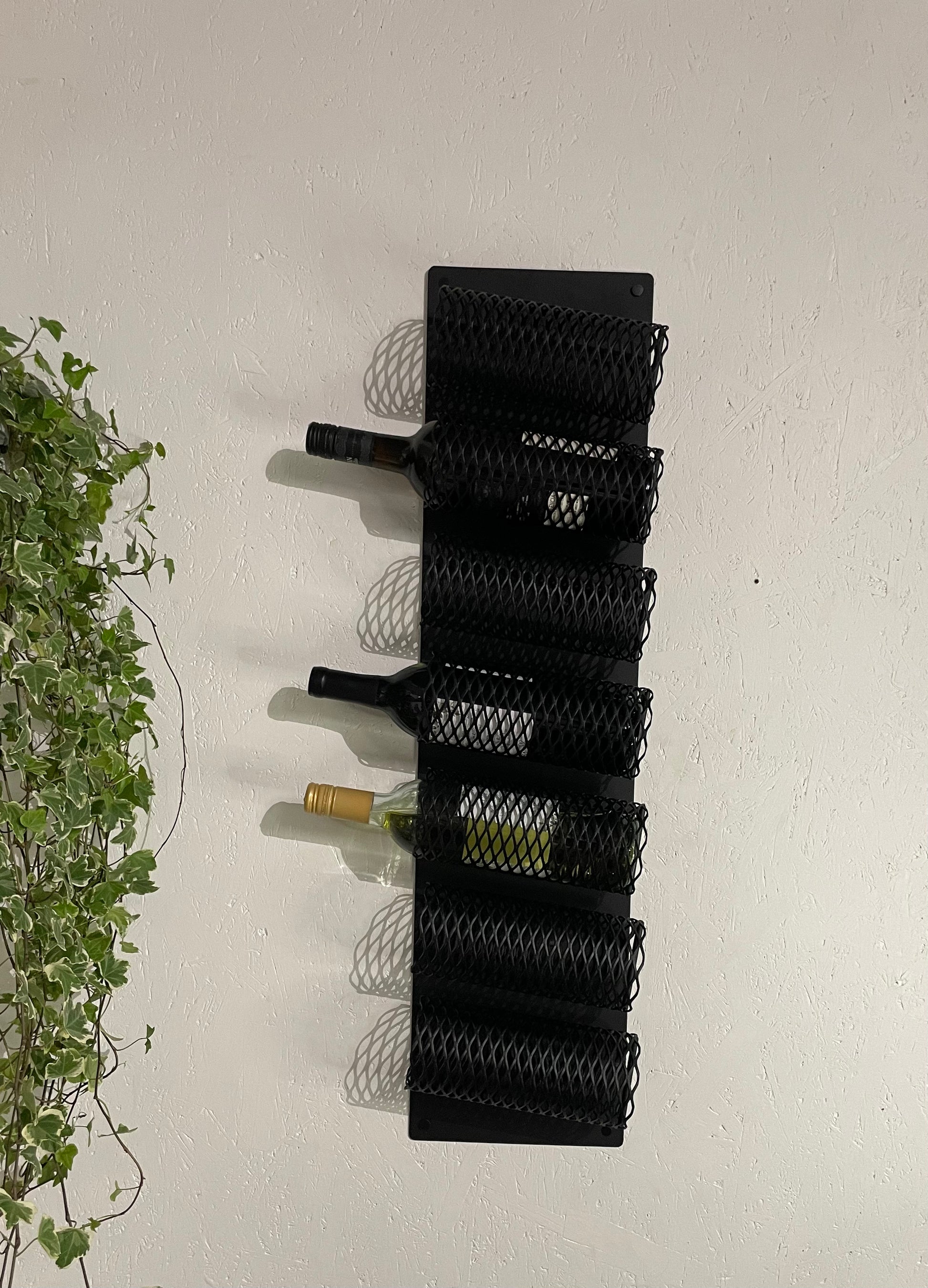 Front view with wine bottles in interior of Wall-Mounted Metal Wine Rack