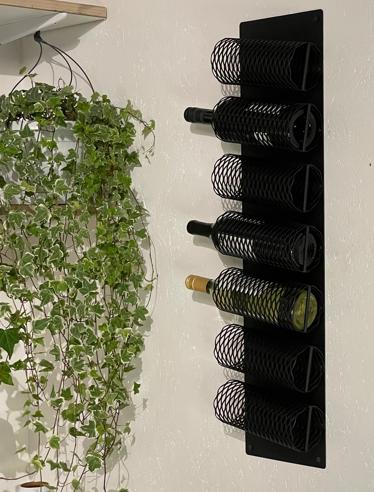 Side view with wine bottles in interior of Wall-Mounted Metal Wine Rack