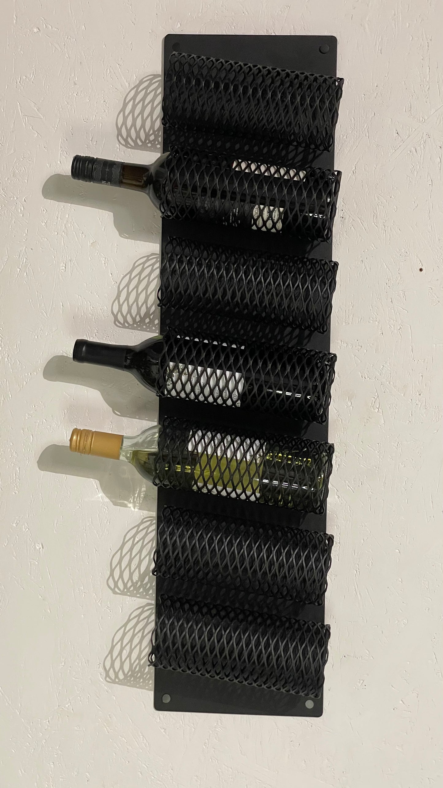 Front view with wine bottles of Wall-Mounted Metal Wine Rack